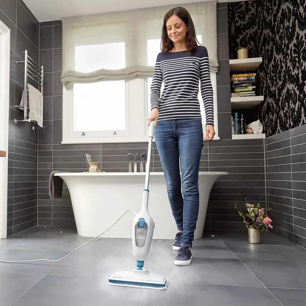 Cleaning the bathroom floor with a steam mop