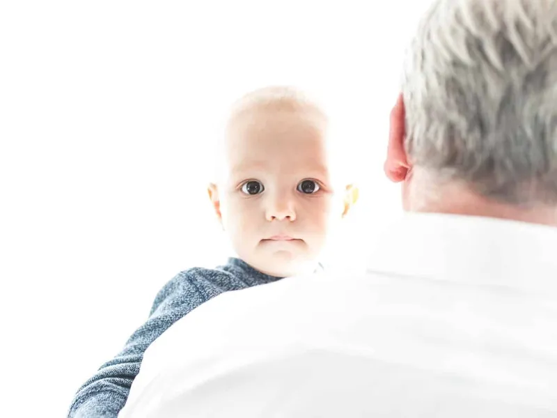 Grandad holding his grandson