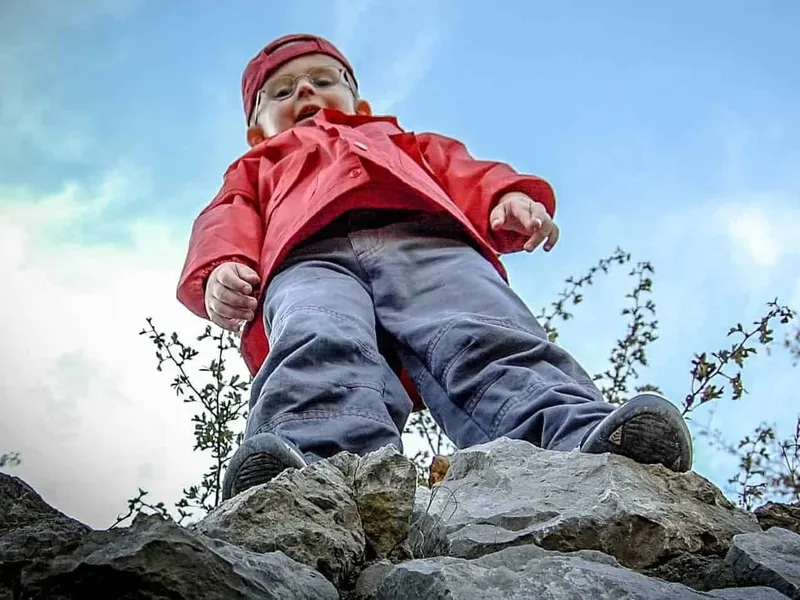 Boy stood on a high rock