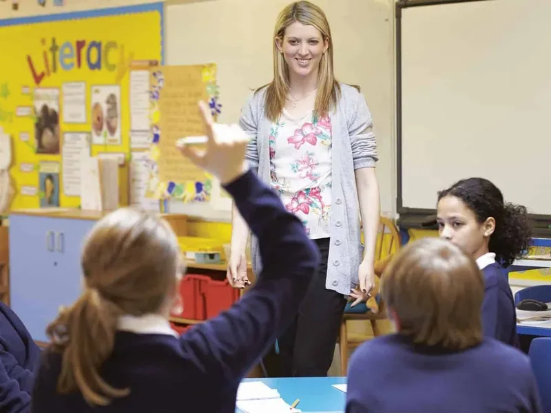 Boys and girls with teacher in class