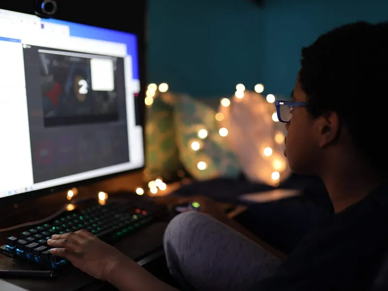 Boy sat in front of a computer screen