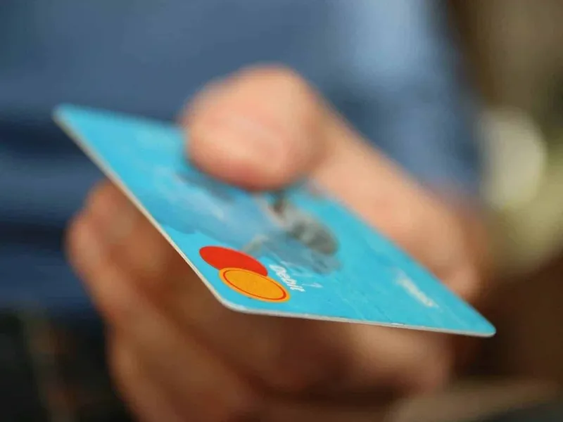 Holding a blue debit card