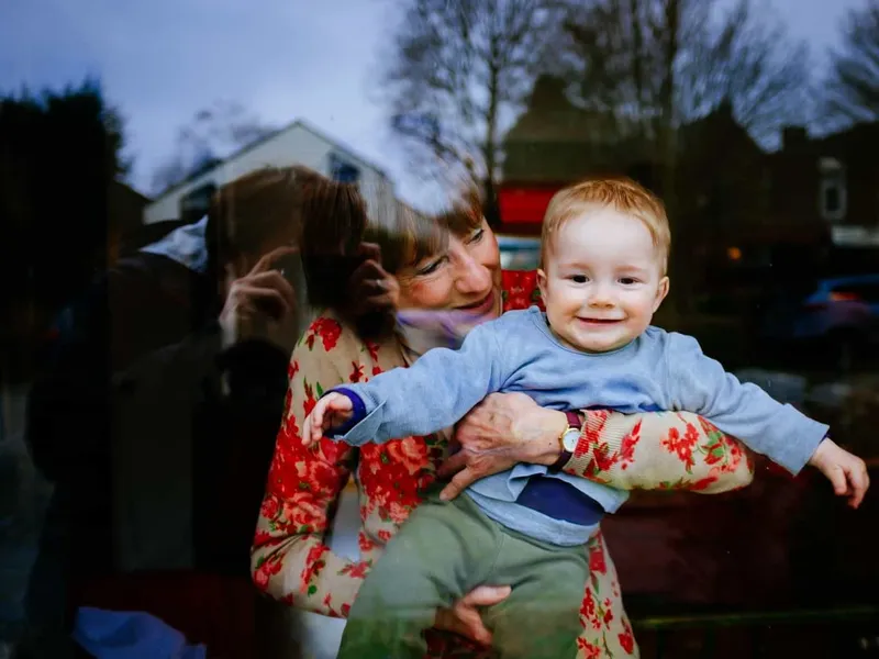 Grandmother and grandson looking out of the window