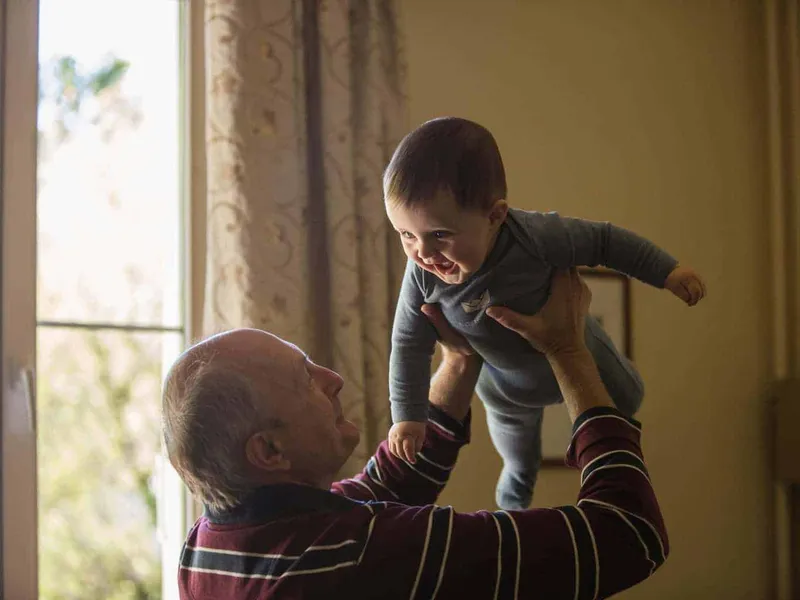 Grandpa holding baby