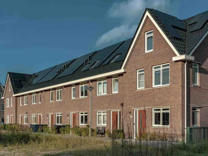 A row of houses with solar panel roofs