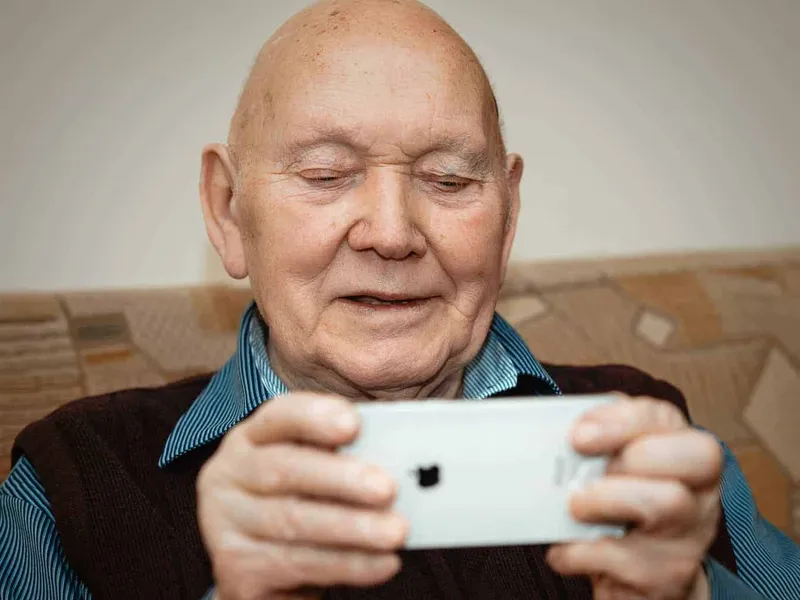 Old man using an iphone