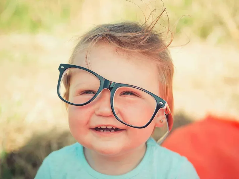 Child with very large pair of glasses